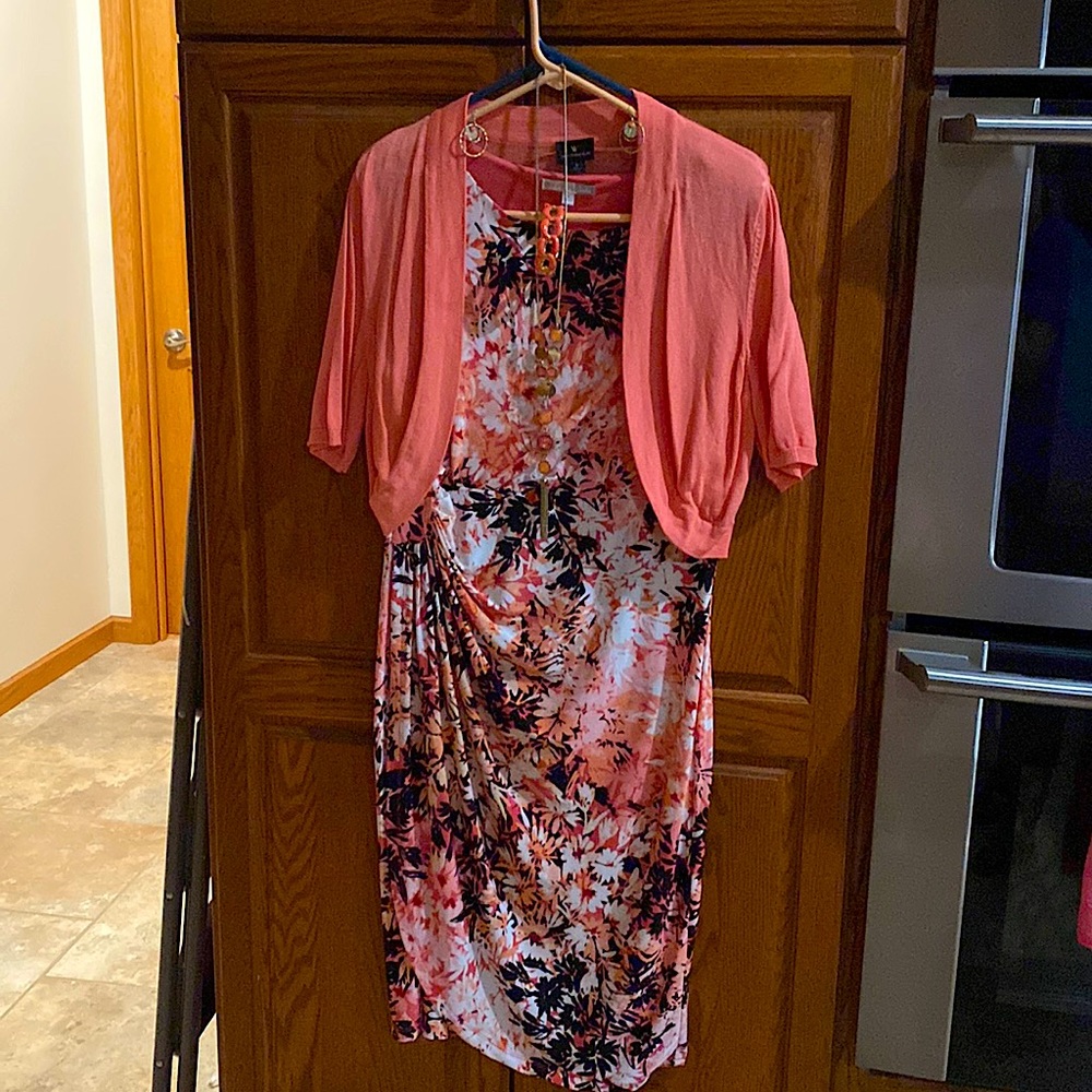 Sleeveless dress and shortsleeved sweater overlay with matching jewelry.